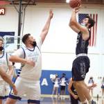 RYAN SPARKS | THE DAILY WORLD Elmas Derique Richey, left, defends the shot of Kings Way Christians Bryce Dodge during the 1A District 4 Championship game on Saturday in Elma. The Eagles lost 64-33.