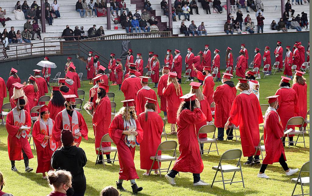 DAN HAMMOCK | THE DAILY WORLD 
Hoquiam High School seniors find their seats at Olympic Stadium on Sunday. Students were allowed eight tickets each, with families socially distanced and masked in the stands.
