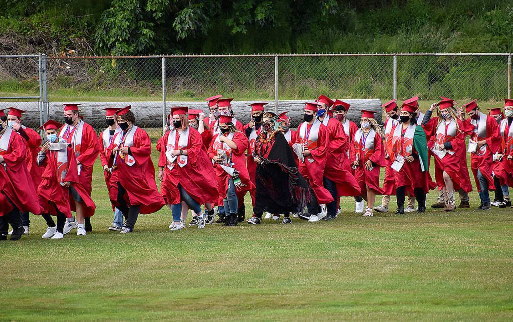 DAN HAMMOCK | THE DAILY WORLD
Soon-to-be Hoquiam High School graduates file into Olympic Stadium Sunday for the 2021 graduation ceremony.