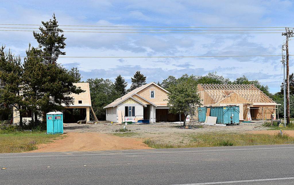 DAN HAMMOCK | THE DAILY WORLD 
Three new single family homes under construction in adjacent lots on Point Brown Avenue in Ocean Shores.