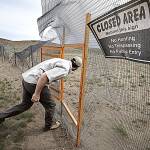 photos by Steve Ringman | The Seattle Times 
Jon Gallie, pygmy rabbit biologist for the Washington Department of Fish and Wildlife, enters a rabbit breeding enclosure in April that was destroyed along with all the rabbits in a 2020 wildfire in the Sagebrush Flat Wildlife Area in Douglas County, setting back the breeding program for years.
