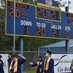 DAN HAMMOCK | THE DAILY WORLD
Aberdeen High School seniors walk to their seats under the scoreboard at Stewart Field on Friday evening.