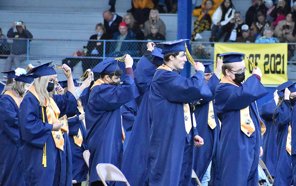DAN HAMMOCK | THE DAILY WORLD
Members of the Aberdeen High School Class of 2021 move their tassels to the left, signifying their graduation, at the end of the ceremony Friday evening at Stewart Field.