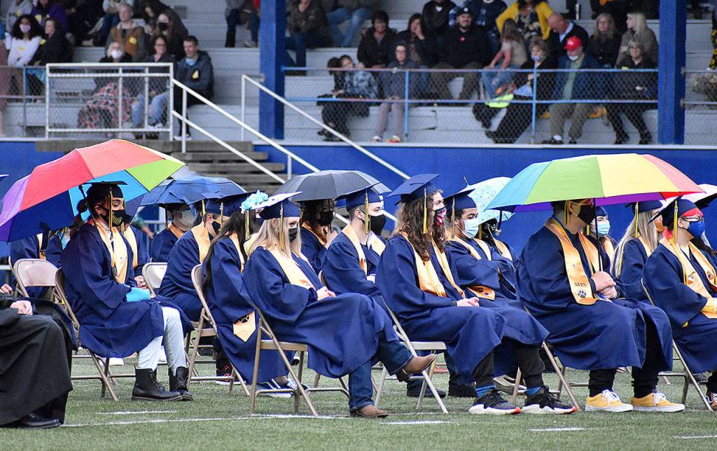 DAN HAMMOCK | THE DAILY WORLD
Umbrellas popped up on several occasions as rain dampened the graduation ceremony