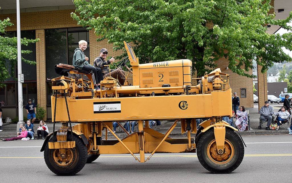 DAN HAMMOCK | THE DAILY WORLD 
Polson Museum Director John Larson gives the thumbs-up as he pilots the museums old Hyster lumber carrier down Market Street during Saturdays Aberdeen Founders Day parade.