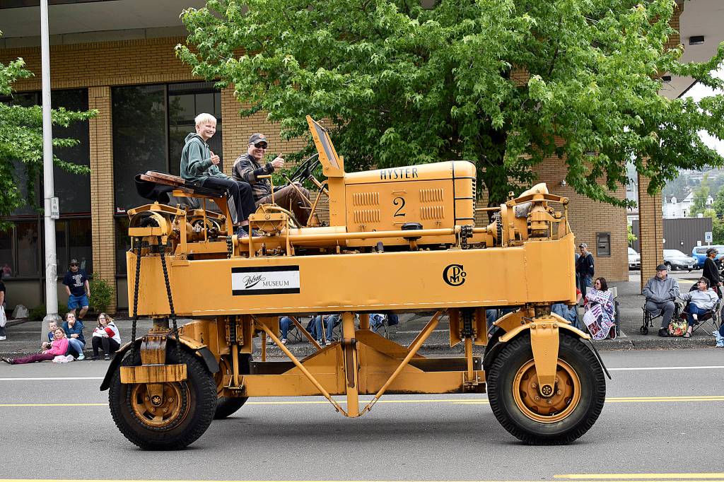 DAN HAMMOCK | THE DAILY WORLD 
Polson Museum Director John Larson gives the thumbs-up as he pilots the museums old Hyster lumber carrier down Market Street during Saturdays Aberdeen Founders Day parade.