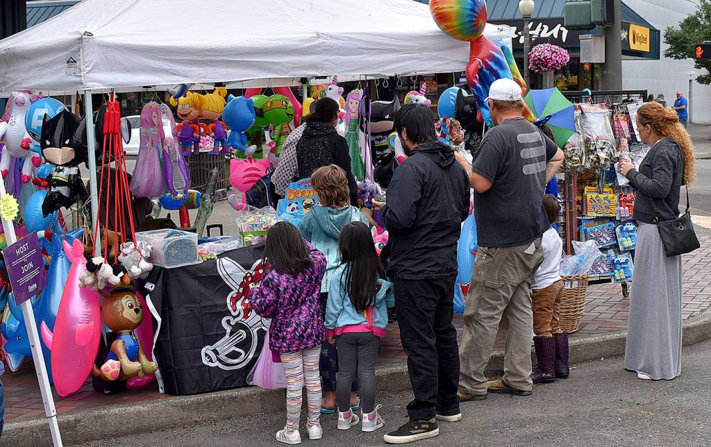 DAN HAMMOCK | THE DAILY WORLD 
Brightly colored inflatable animals, swords and the like were popular among the younger revelers at Saturdays Aberdeen Founders Day celebration.