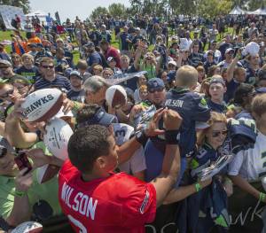 Steve Ringman | Seattle Times file photo 
Seattle Seahawks quarterback Russell Wilson signs autographs during a past training camp in Renton.