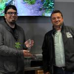 DAVE HAVILAND | THE DAILY WORLD
The Daily World publisher Mike Hrycko presents the "Best Overall Business" crystal trophy to Adam Bakotich