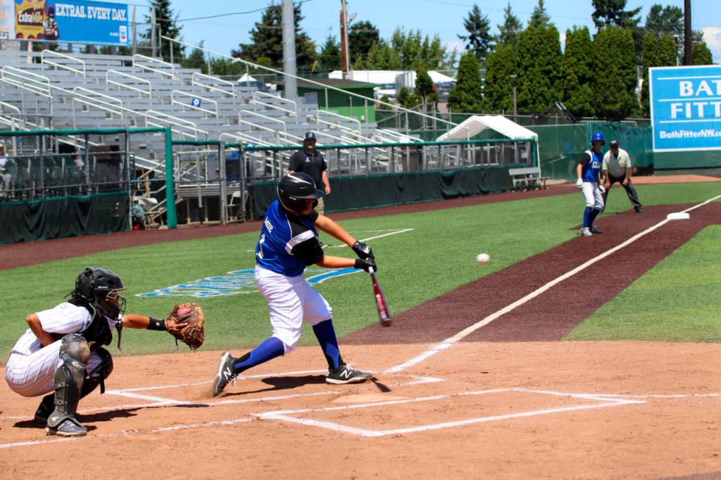 PHOTO BY AMY SPOON Tanner Moe smacks one of Elmas 16 base hits in a 12-5 victory in the Washington State Little League Championship Game on Thursday in Everett.