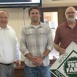 Courtesy City of Hoquiam 
Grays Harbor Conservation District foresters David Houk, center, and Jim Getchman, right, presented Hoquiam Mayor Ben Winkelman a marker for the citys recently-certified watershed tree farm.