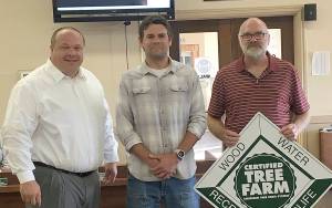 Courtesy City of Hoquiam 
Grays Harbor Conservation District foresters David Houk, center, and Jim Getchman, right, presented Hoquiam Mayor Ben Winkelman a marker for the citys recently-certified watershed tree farm.