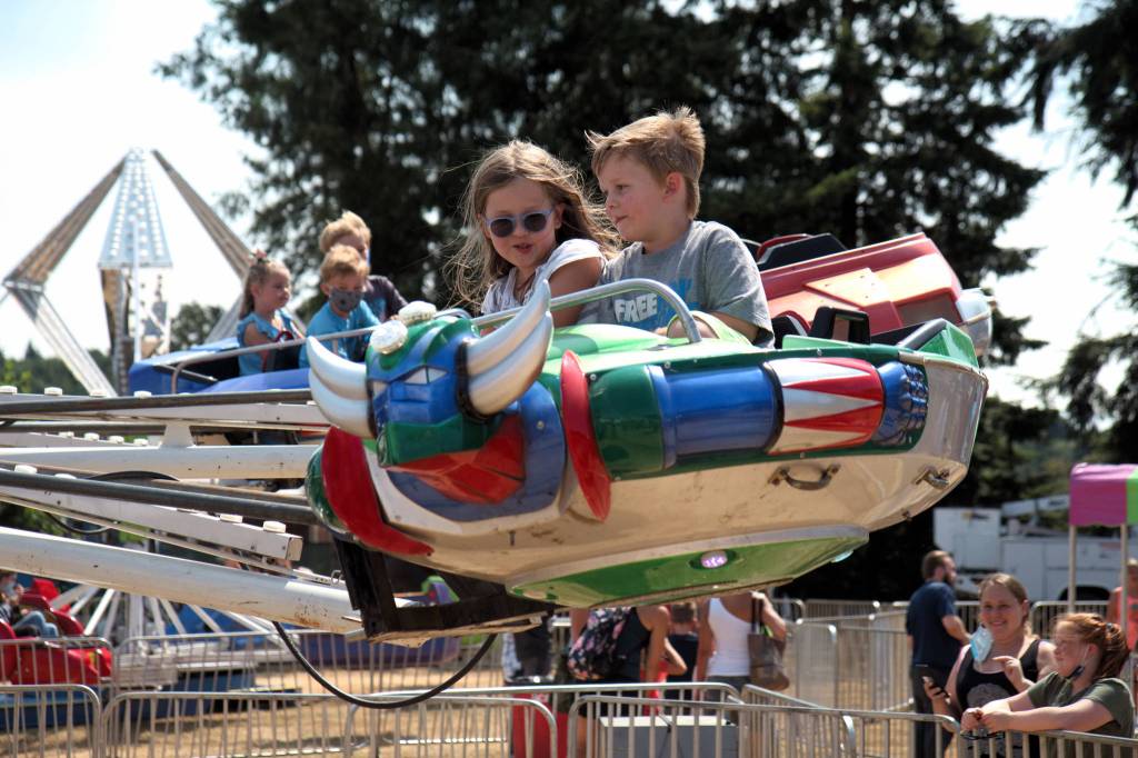 RYAN SPARKS | THE DAILY WORLD A pair of children enjoy a ride during the Grays Harbor County Fair on Thursday in Elma.