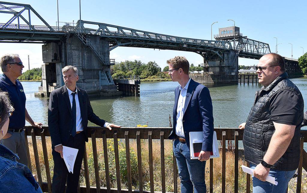 DAN HAMMOCK | THE DAILY WORLD 
From left, Port of Grays Harbor Deputy Executive Director Leonard Barnes, Hoquiam City Administrator Brian Shay, Congressman Derek Kilmer and Hoquiam Mayor Ben Winkelman stand behind the Hoquiam Farmers Market on Friday discussing the alignment of the North Shore Levee and its extension, the North Shore Levee West Segment.