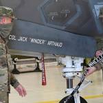 U.S. Air Force photo by Senior Airman Heather LeVeille 
From left, U.S. Air Force Senior Airman Joshua Owens and Staff Sgt. Hunter Davis, 33rd Aircraft Maintenance Squadron crew chiefs, reveals the name of Col. Jack Arthaud, 33rd Fighter Wing commander, on aircraft 50-33 during a change of command ceremony at Eglin Air Force Base, Fla., on July 30, 2021. Davis and Owens have been charged with the care and maintenance of aircraft 50-33.