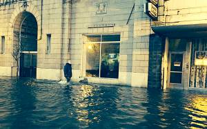 daily world File photo
A pedestrian wades through deep water in front of the Becker Building at the corner of Wishkah and I streets in Aberdeen after heavy rains caused widespread flooding on Jan. 4, 2014.