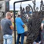 DAN HAMMOCK | THE DAILY WORLD 
Tokeland metal artist Yoseph Adams booth drew a crowd, as usual, at Saturdays Tokeland Woodfest.