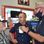 DAN HAMMOCK | THE DAILY WORLD 
Doug McDowell, left, chats with Aberdeen Police Chief Steve Shumate, center, and Hoquiam Police Chief Jeff Myers at McDowells final KBKW broadcast at the Hoquiam Farmers Market Tuesday morning.