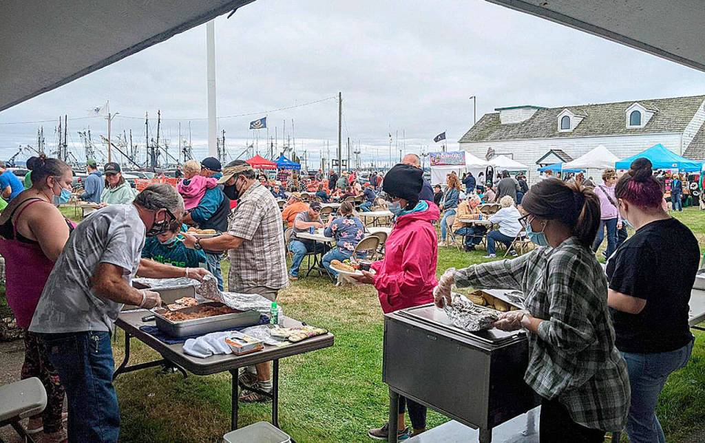 Volunteer grillers prepare oysters, salmon, white fish and sides at the Westport Seafood Festival Saturday. The barbecue grills were hot and hundreds went through the food line and vendor tents set up in front of the Westport Maritime Museum from noon to 5 p.m. (Courtesy Westport Grayland Chamber of Commerce)
