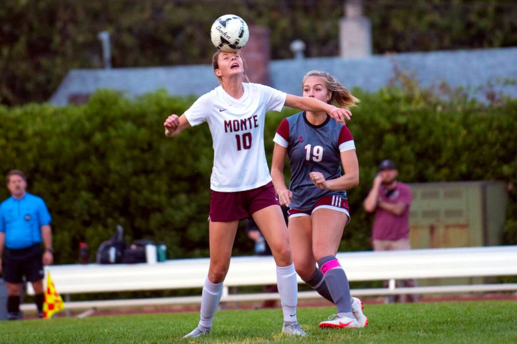 ERIC TRENT | THE CHRONICLE Montesanos Mikayla Stanfield (10) heads the ball in front of WF Wests Kyla McCallum during the Bulldogs 2-1 victory on Tuesday in Chehalis.