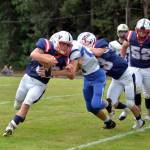 RYAN SPARKS | THE DAILY WORLD Pe Ell-Willapa Valley running back Blake Howard, left, carries against Adna during the Titans 26-8 loss to the Pirates on Saturday in Menlo.