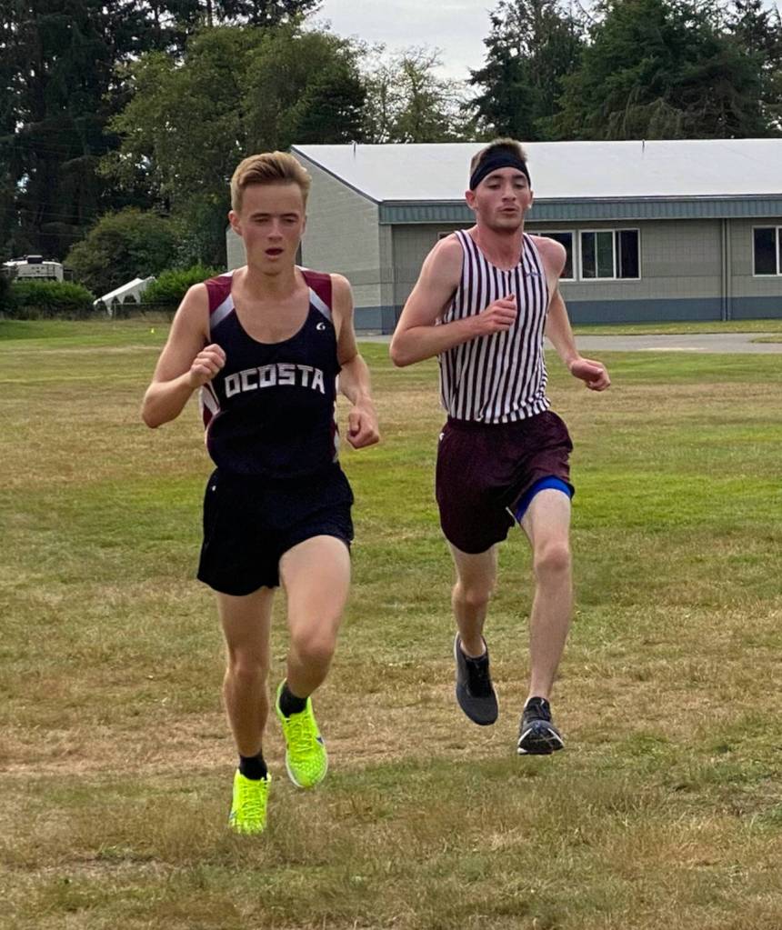 SUBMITTED PHOTO Ocostas Dylan Todd, left, and Montesanos Aric Jacklin crossed the finish line 1-2, respectively, at the Ocosta Invitational cross country meet on Saturday in Westport.