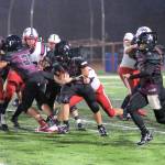 RYAN SPARKS | THE DAILY WORLD Raymond-South Bend running back Ty Reidinger, middle, rushes against PWV on Friday at Millam Field in South Bend.