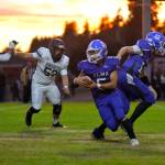 RYAN SPARKS | THE DAILY WORLD Elma running back Manny Hernandez takes the handoff from quarterback Carter Studer (12) during the first half of Elmas 66-25 victory over Kings Way Christian on Friday at Davis Field in Elma.