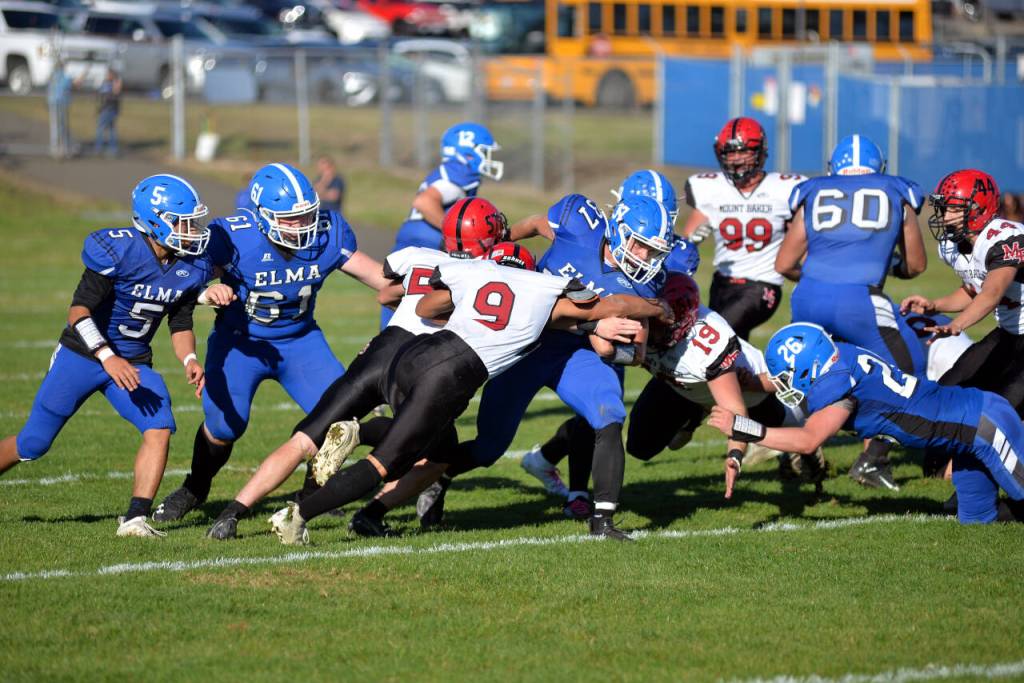 RYAN SPARKS | THE DAILY WORLD Elma running back Jarred Bailey (37) is met by Mt. Baker defender Marques George (9) during a game on Saturday at Davis Field in Elma.