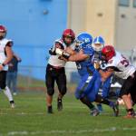 RYAN SPARKS | THE DAILY WORLD Elma defensive lineman Tucker Potts (65) tackles Mt. Baker running back Jesse Sande during the second half of Elmas 28-13 loss on Saturday in Elma.