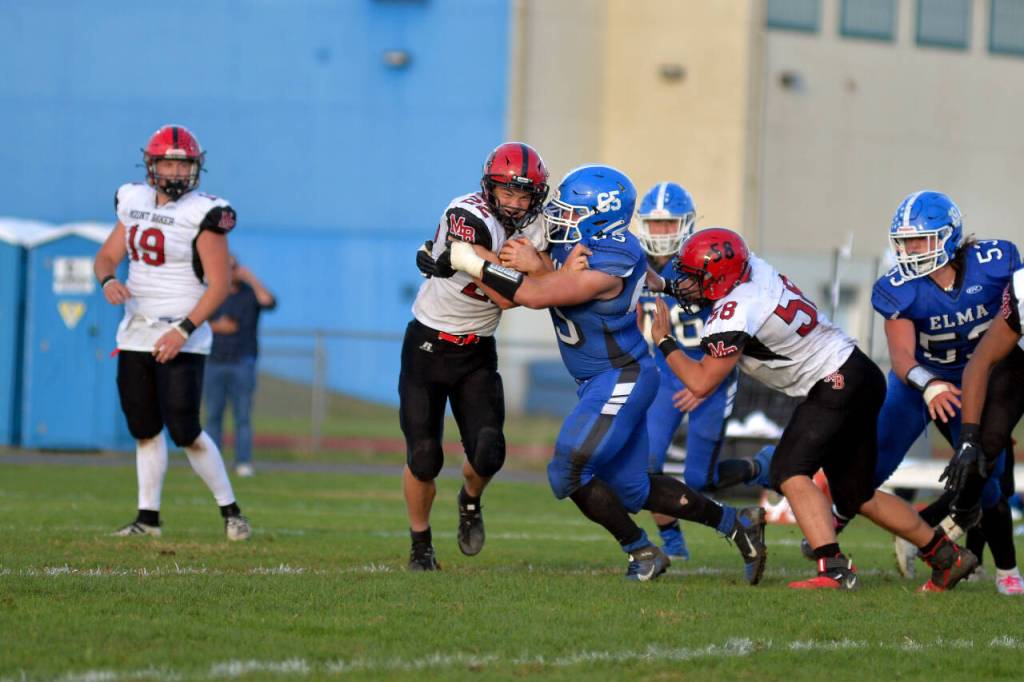 RYAN SPARKS | THE DAILY WORLD Elma defensive lineman Tucker Potts (65) tackles Mt. Baker running back Jesse Sande during the second half of Elmas 28-13 loss on Saturday in Elma.