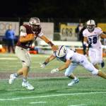RYAN SPARKS | THE DAILY WORLD Montesano quarterback Jayden McElravy, left, avoids the tackle of Eatonville defensive back Austin Wicker during Montes 35-18 loss on Friday in Montesano.