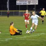 RYAN SPARKS | THE DAILY WORLD Elma forward Beta Valentine (12) tries to get past Hoquiam goal keeper Katie Burnett during Elmas 7-0 victory on Thursday at Olympic Stadium in Hoquiam. Valentine scored three goals to lead the Eagles.