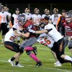 RYAN SPARKS | THE DAILY WORLD Hoquiam running back Anthony Burtenshaw (48) carries a host of Centralia Tigers during the Grizzlies 29-14 loss on Friday at Olympic Stadium in Hoquiam. Burtenshaw rushed for 103 yards in the loss.