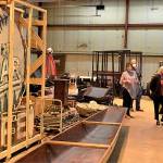 Courtesy of Aberdeen museum board
Aberdeen museum board member George Donovan and two people from the Washington State Historical Society tour the collection in its current location, a warehouse in the Port district. At the left is the last neon sign that hung outside the Spar Cafe, discovered in the armory building annex after the armory fire.