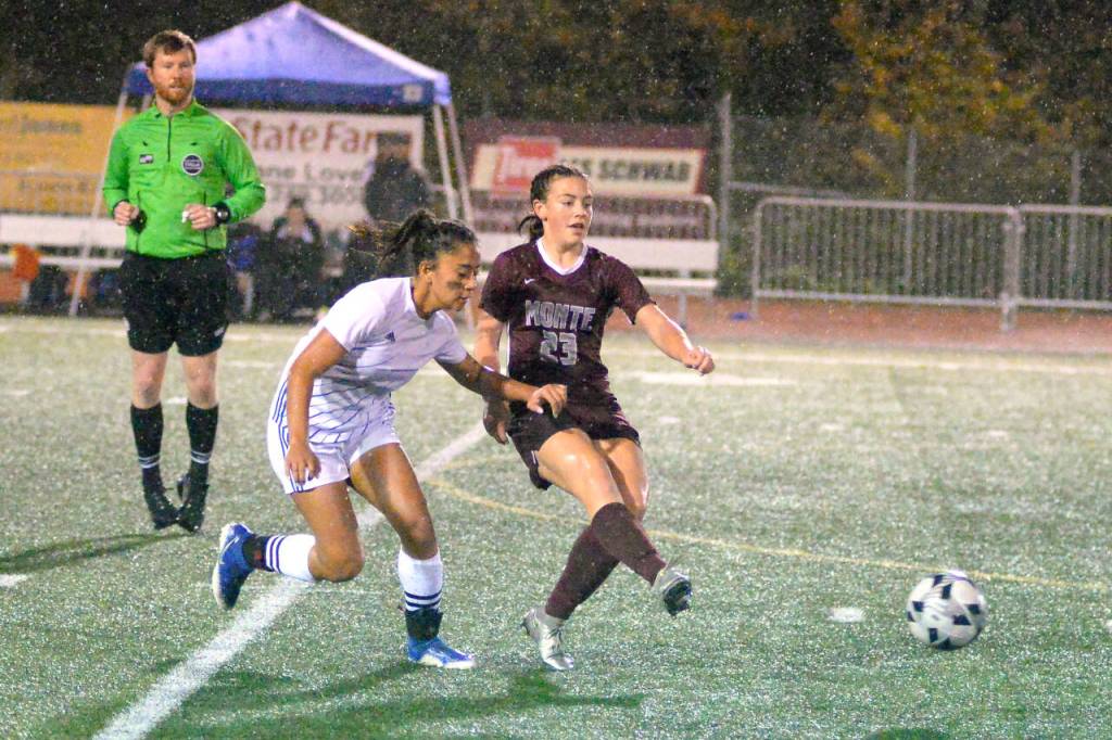 RYAN SPARKS | THE DAILY WORLD Montesano midfielder Jaiden King (23) passes the ball away from Elma midfielder Eliza Sibbett during Montes 1-0 win on Thursday in Montesano.