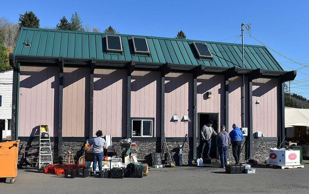 DAN HAMMOCK | THE DAILY WORLD 
Frankos Farmstand staff clean up after a fire Saturday morning. The farm stand was closed Saturday but able to reopen for regular hours Sunday.