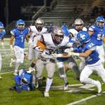 RYAN SPARKS | THE DAILY WORLD Montesano running back Isaiah Pierce (31) sheds La Center defenders during the Bulldogs 42-20 victory on Friday in Woodland. Pierce ran for 208 yards and scored four touchdowns in the 1A Southwest District playoff victory.