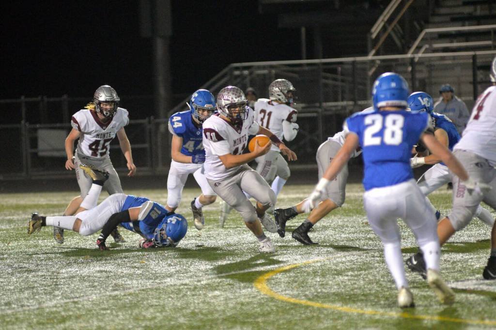 RYAN SPARKS | THE DAILY WORLD Montesano quarterback Jayden McElravy carries for a first down against the La Center Wildcats in a 1A play-in game on Friday in Woodland. Montesano advanced to the state tournament with a 42-20 victory over the Trico League champions.