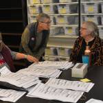 Challenger Susan Conniry (middle) confers with incumbent Crystal Dingler (right) while election worker Kathye Lano (left) sorts the ballots in 2019s Ocean Shores mayoral race hand count. Dingler won a third term by three votes. (File photo)