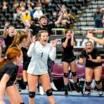 ERIC TRENT | THE CHRONICLE Raymonds Kyndal Koski (1) and Karsyn Freeman, right, celebrate with their teammates after scoring a point against Walla Walla Academy in the 2B State Volleyball Tournament semifinals on Friday at the SunDome in Yakima.