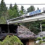 DAN HAMMOCK | THE DAILY WORLD, file 
An Aberdeen ladder truck stands by as firefighters mop up a house fire on Duffy Street in July 2019.