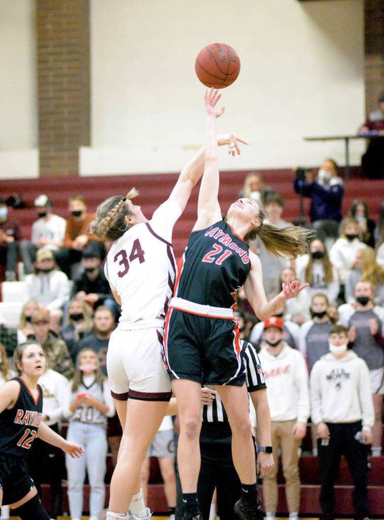 RYAN SPARKS | THE DAILY WORLD Raymond guard Kyra Gardner (21) and Montesano forward McKynnlie Dalan leap for the ball at the opening tip-off in a non-league game on Friday at Montesano High School. Montesano went on to win the game 54-51.