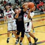 RYAN SPARKS | THE DAILY WORLD Ocostas Xander Prigmore (22) and Raymond Adrian Quintana (14) compete for a rebound during the Seagulls 87-53 victory on Wednesday at Raymond High School.