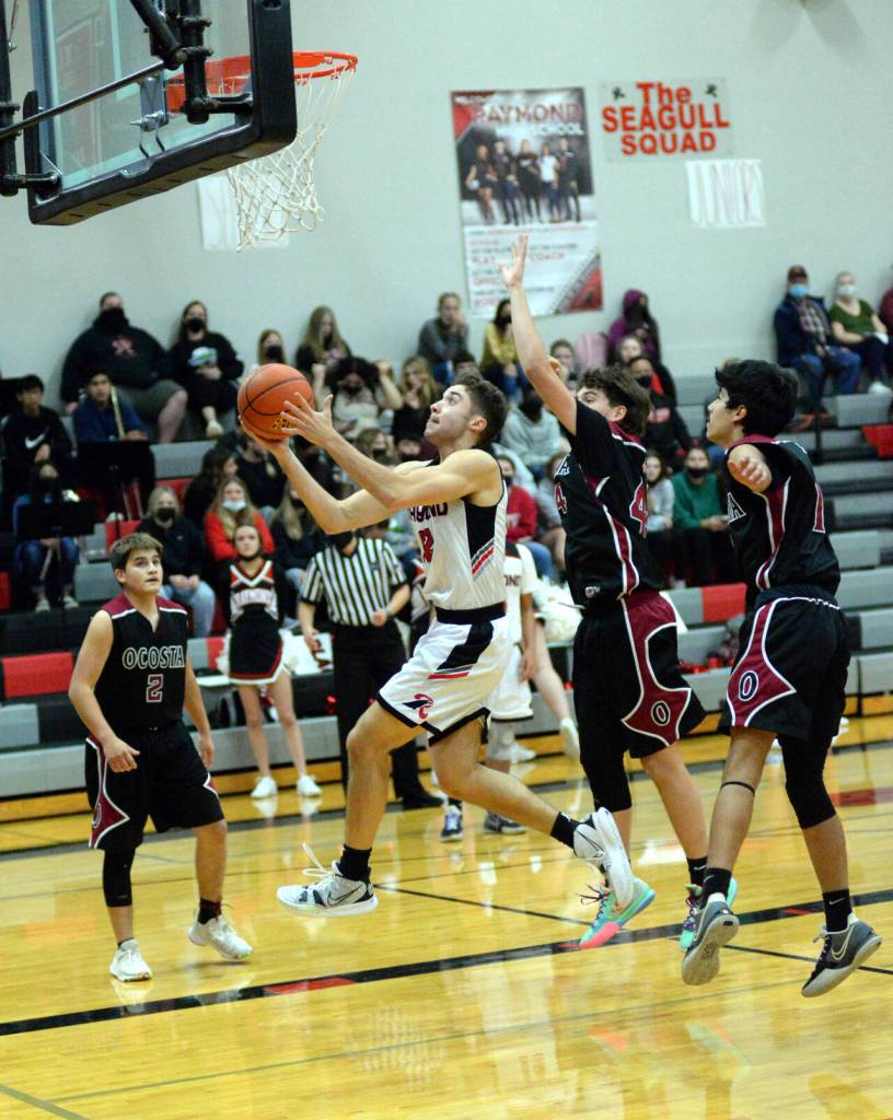 RYAN SPARKS | THE DAILY WORLD Raymond senior Tre Seydel (12) coasts to the basket for two of his game-high 29 points during the Seagulls 87-53 victory on Wednesday in Raymond.