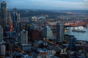 Don Bartletti | Los Angeles Times, file photo 
Twilight settles over Seattle and its waterfront in a view from the Space Needle on Jan. 16, 2015. Ferry boats from Pier 50 cross Puget Sound to Bainbridge Island. The Seattle Ferris Wheel is on Pier 57.