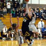 RYAN SPARKS | THE DAILY WORLD North Beach point guard Josh Bighead (20) drives to the basket while being defended by Montesanos Trent Adams (23) and Jackson Busz in the second half of the Hyaks 46-34 victory on Wednesday at Bo Griffith Memorial Gymnasium in Montesano.