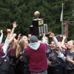 DAILY WORLD FILE PHOTO The Montesano Bulldogs softball team raises a district championship trophy after defeating Castle Rock 4-0 in April.