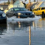 Matthew N. Wells | The Daily World 
A Pontiac sedan causes a wake after high tide on Monday afternoon, Jan. 3, 2022, down East 1st Street and North F Street in Aberdeen. Flooding throughout Aberdeen and Hoquiam caused plenty of turnarounds.