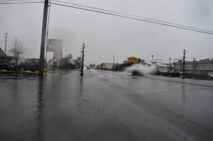 A driver in a white pickup truck sprays floodwater Thursday afternoon, Jan. 6, 2022, just outside of Dennys, 418 W. Heron St., in Aberdeen. Countless other vehicles did the same thing as they made their way on and through Heron Street. Matthew N. Wells | The Daily World